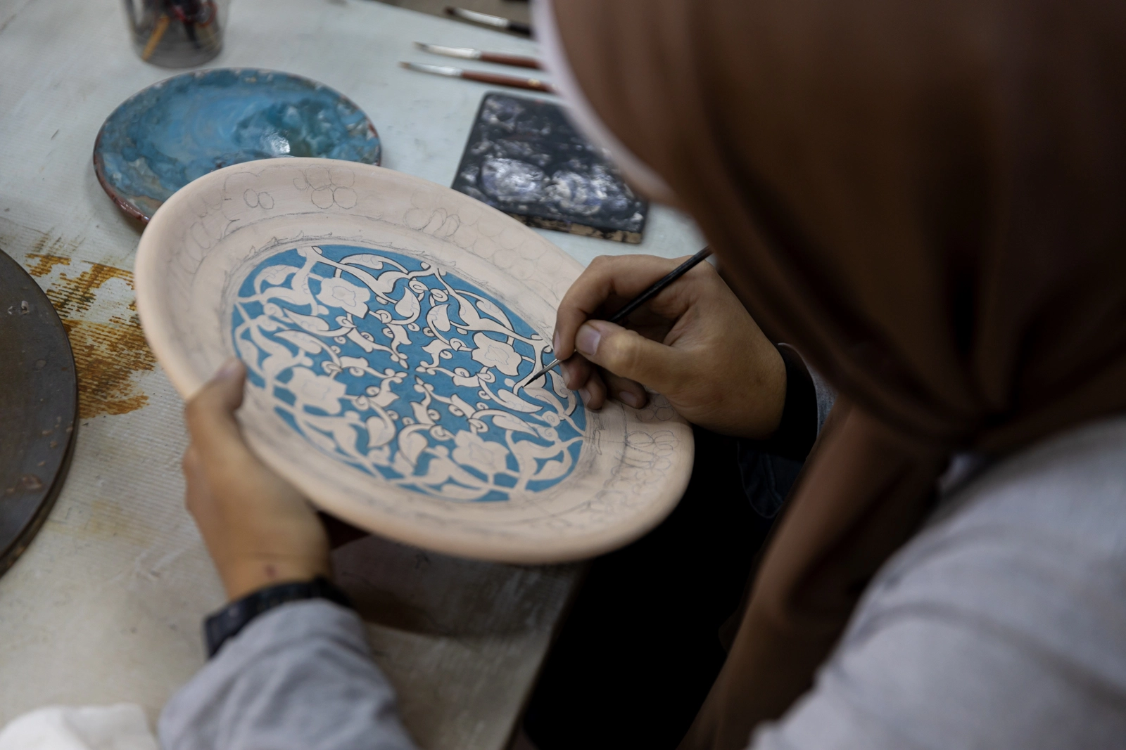 Students studying and creating traditional Islamic floral motifs